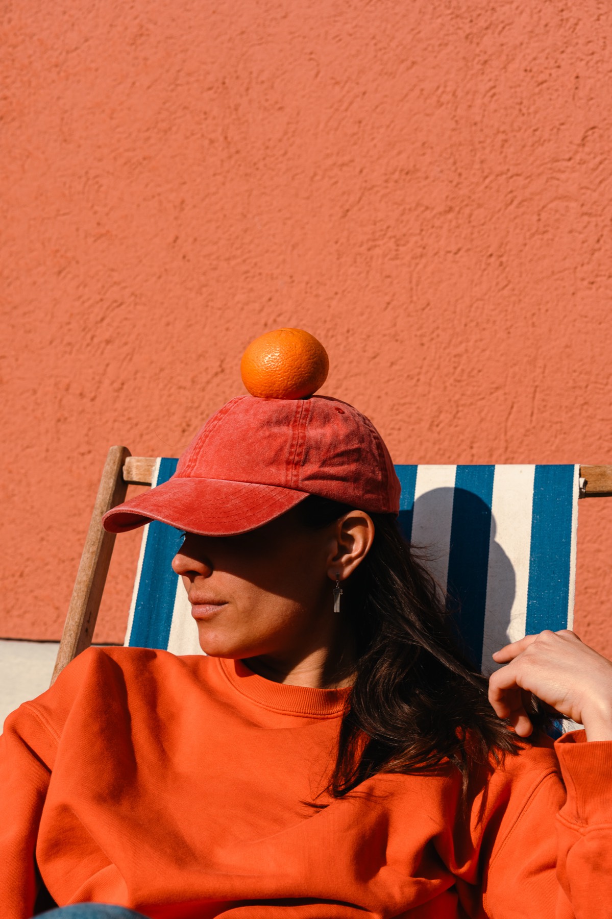 Cinzia smiling and holding a citron in front of her face