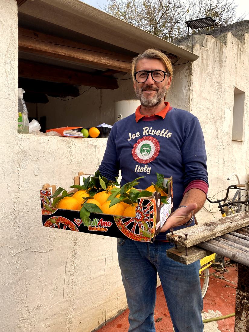Emilio at Casa del Gelso with a freshly picked box of oranges